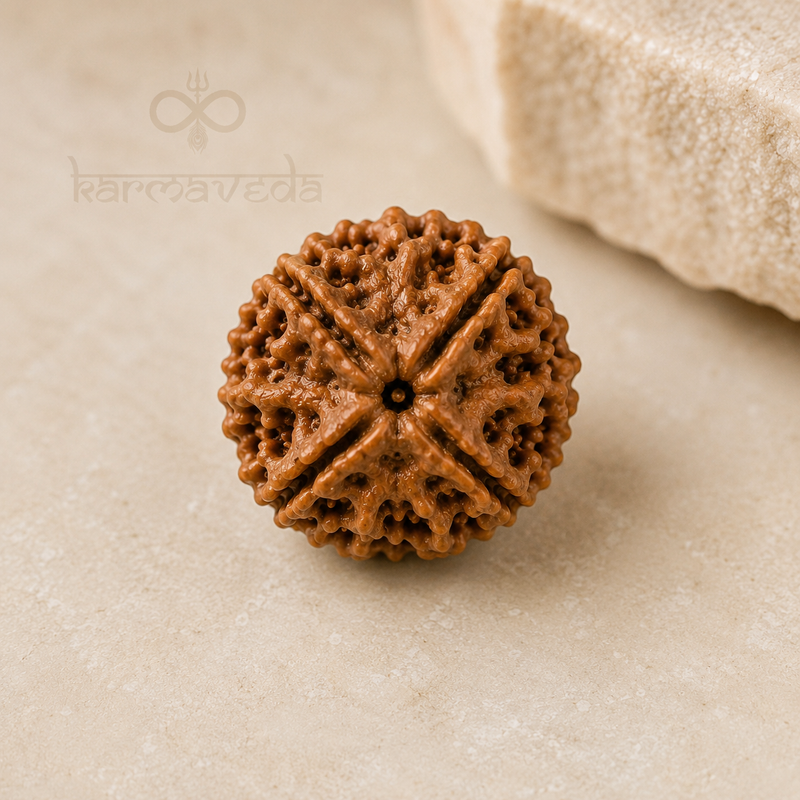 Brown textured object on a beige surface with 'karmaveda' branding.