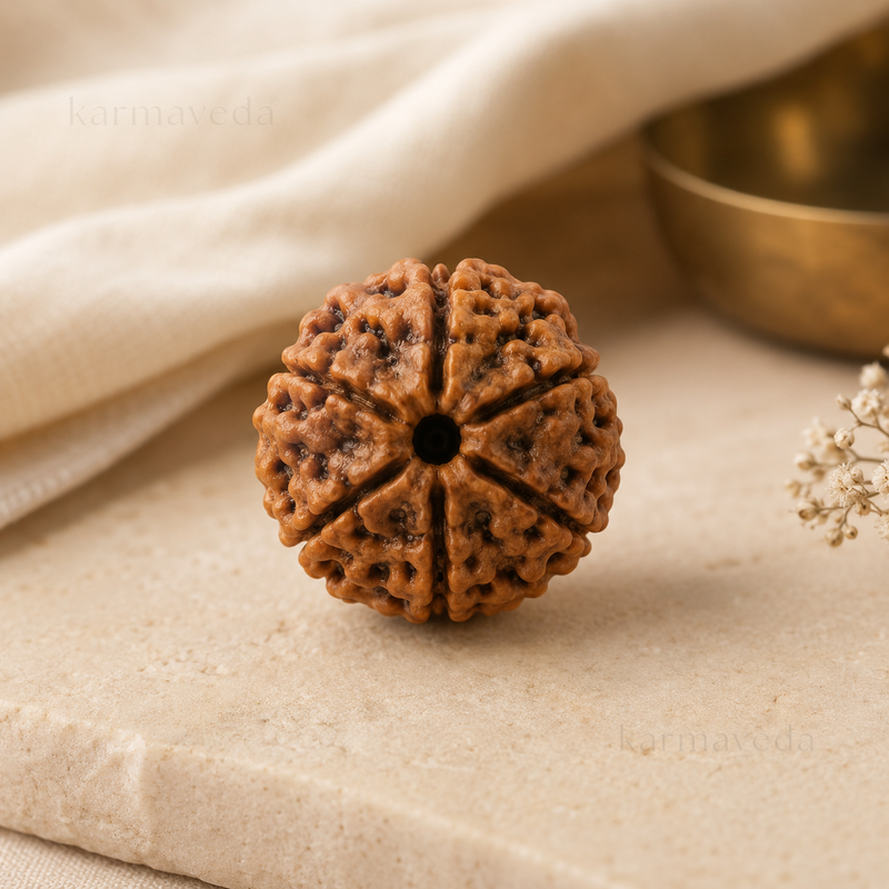 Brown textured object on a beige surface with a gold bowl in the background