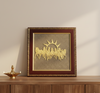 Decorative wall art with gold horses and sun design in a brown frame on a wooden surface.
