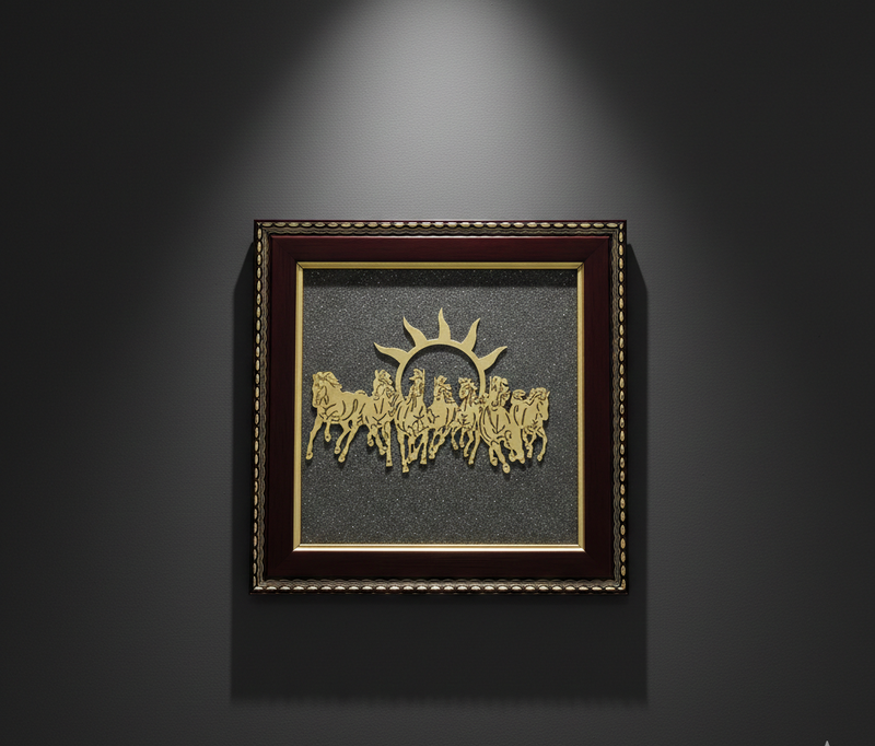 Decorative wall art with gold horses and sun design in a dark frame on a gray background