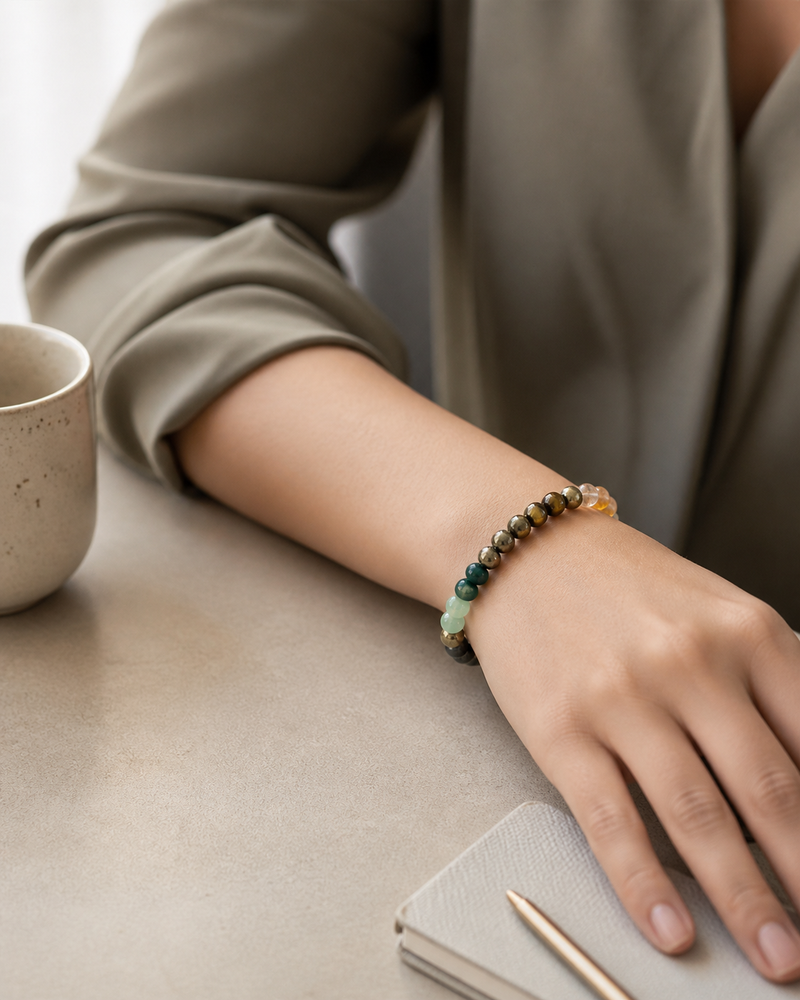 Person wearing a beaded bracelet on a desk