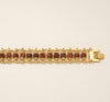 Gold bracelet with brown beads on a beige background