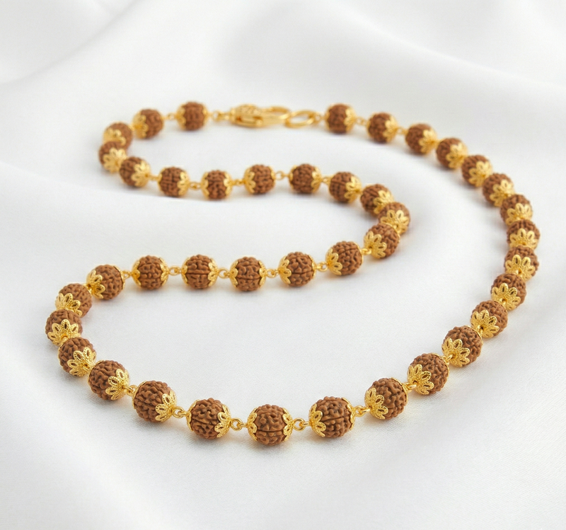 Necklace with brown and gold beads on a white background