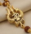 Gold necklace with intricate design and brown beads on a beige fabric background