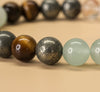 Close-up of a bracelet with various colored beads on a beige background