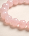 Close-up of a pink beaded bracelet on a light background