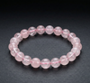 Pink beaded bracelet on a dark surface