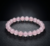 Pink beaded bracelet on a dark surface