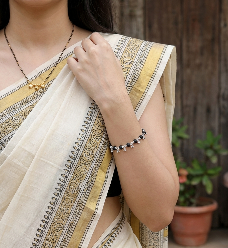 Person wearing a patterned saree with a blurred background