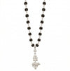 Black beaded necklace with a silver pendant on a white background