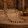 Necklace with multicolored beads on a stone surface with a blurred background
