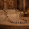 Necklace with multicolored beads on a stone surface with a blurred background