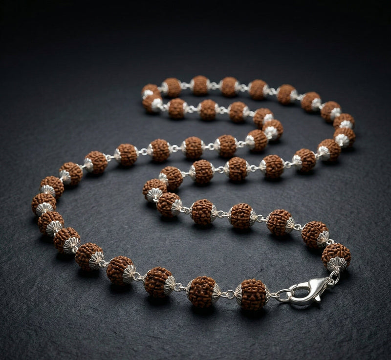 Necklace with brown and silver beads on a dark background