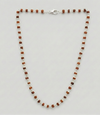 Necklace with alternating brown and white beads on a light gray background