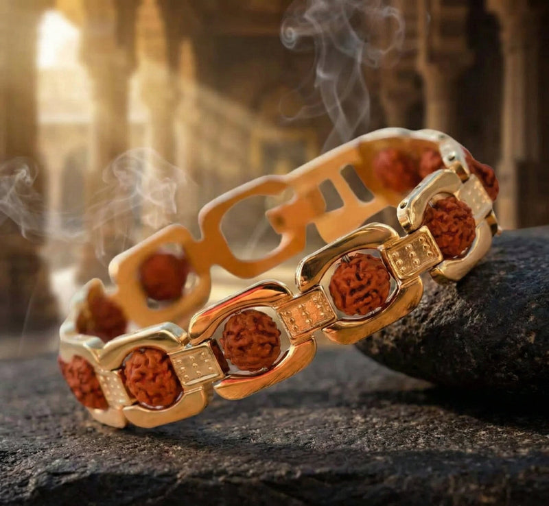 Gold and brown bracelet on a textured surface with a blurred background
