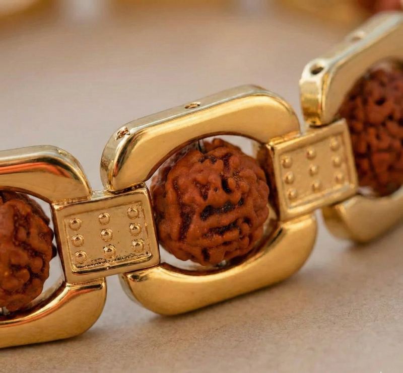 Gold bracelet with brown beads on a beige background