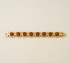 Gold bracelet with brown stones on a beige background